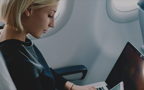 Woman with a laptop on a plane